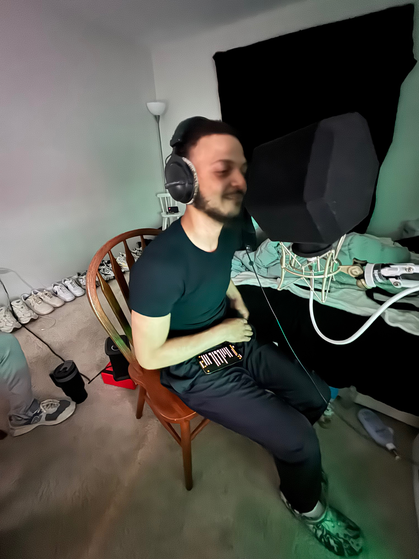 Vocalist recording with Beyerdynamic DT 770 headphones and pop filter